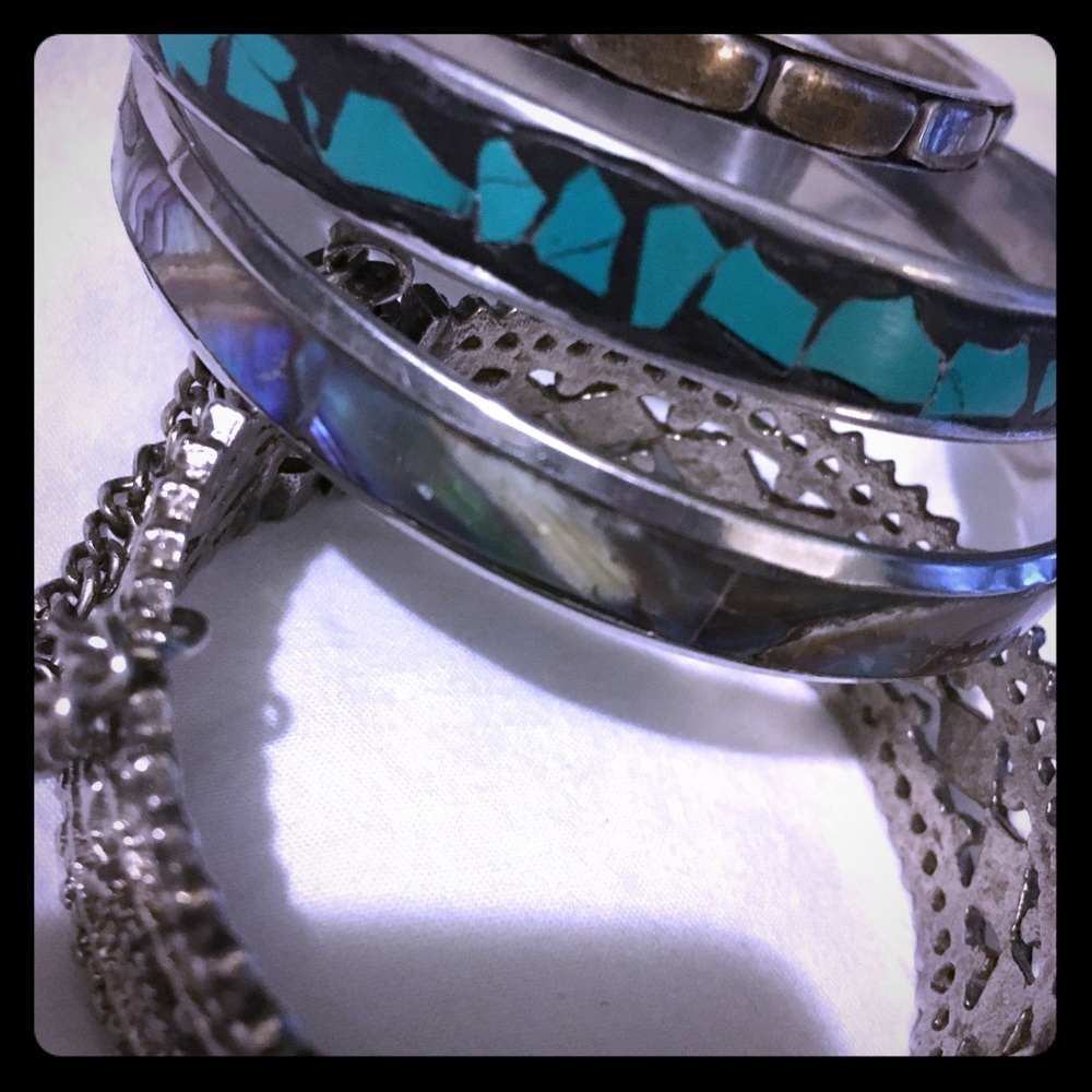 Four silver Tone bracelets.